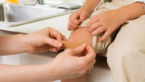 Physician plasing an adhesive on a patient's knee