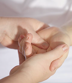 Applying preassure-based massage in a child's hand Applying preassure-based massage in a child's hand